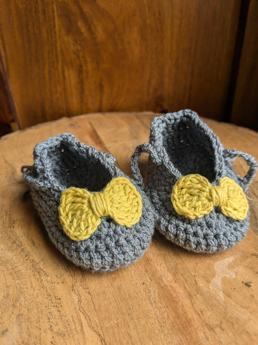 Grey baby booties with yellow bow